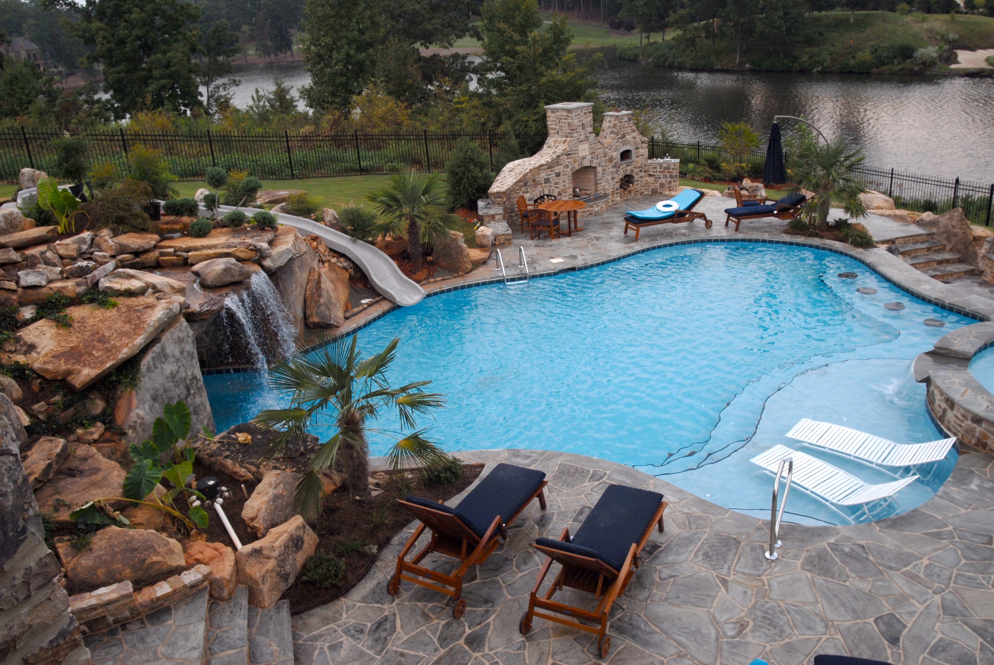 Resort-style inground pool with fire bowls and waterfall features in Tennessee